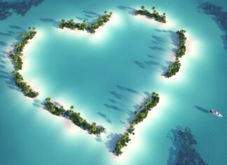 Heart shaped island greenery surrounded by turquoise waters in Indian Ocean