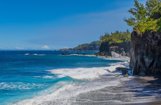 Rocky coastline with waves crashing on the shore of the Indian Ocean
