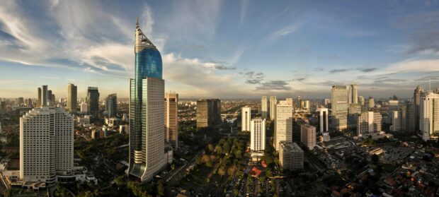 A panoramic view of Jakarta cityscape featuring modern skyscrapers and urban greenery in Indonesia