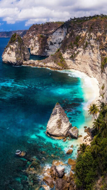 A stunning view of Indonesia coastline with turquoise waters and rocky cliffs