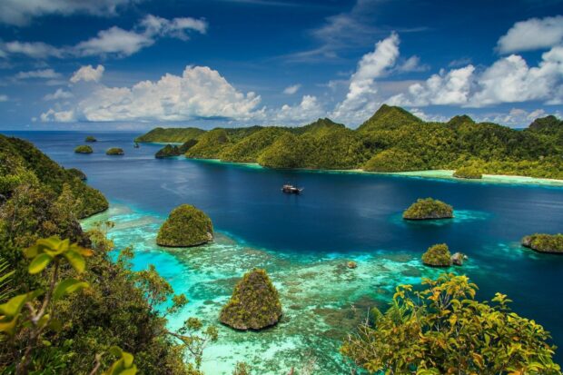 A stunning view of Indonesia with green islands and clear blue water under a bright sky