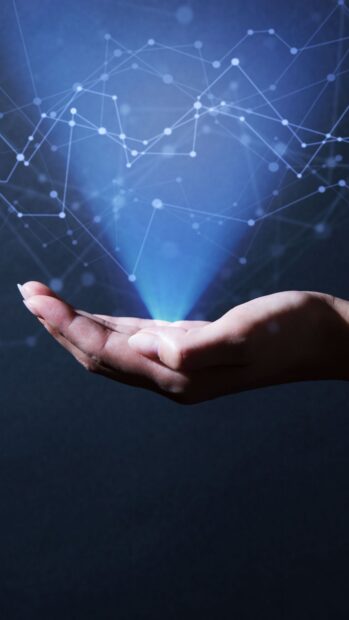 A hand projecting innovation concept with connected network nodes and glowing blue light