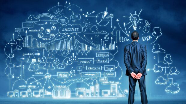 A businessman examining innovation concepts and growth charts on a blue digital wall