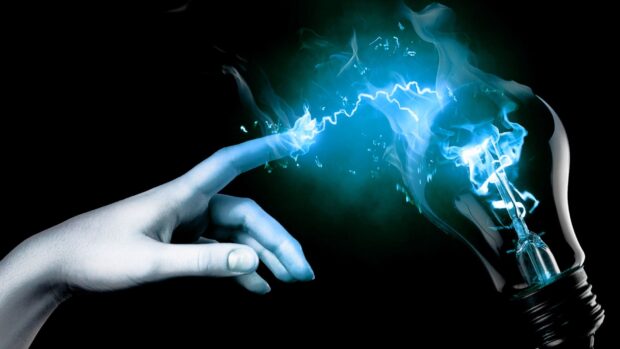 A hand creating electric sparks connecting to a glowing light bulb symbolizing innovation