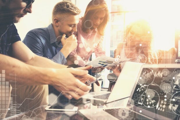 A business team discussing innovation strategy and data analysis in an office environment