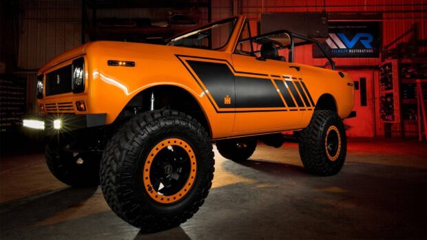Orange International Harvester truck with black details in a garage setting
