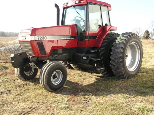 Red International Harvester tractor 7230 parked on a grassy field