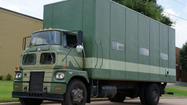 Vintage International Harvester truck parked on a street in green color