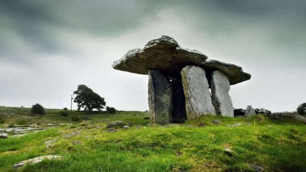 Ancient megalithic structure in the Irish countryside surrounded by green grass