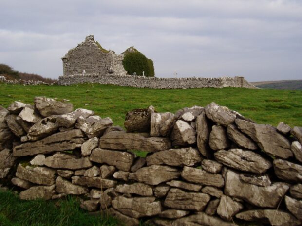 Ancient stone walls and lush green fields in the Irish countryside landscape