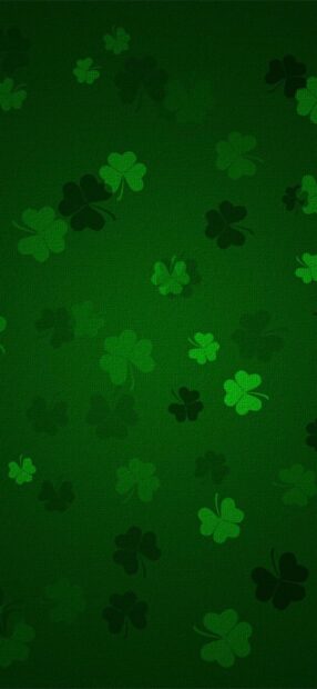 Various shades of green shamrock pattern on a dark green texture background