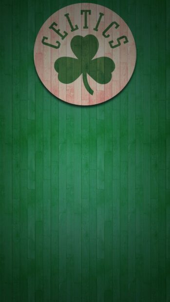 Celtic text with a green shamrock on a wooden floor