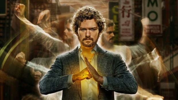 A man demonstrating Iron Fist power with glowing hand in a dynamic martial arts pose
