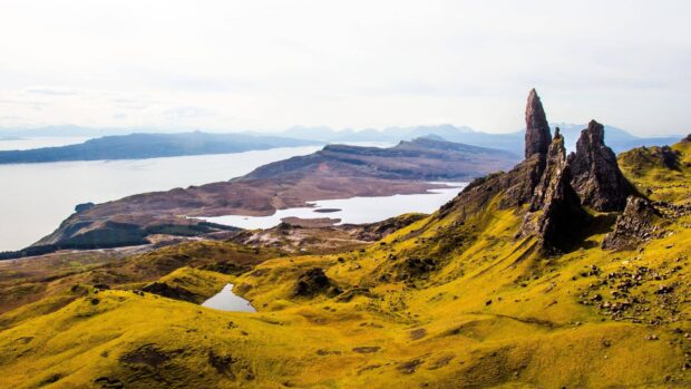 The Isle of Skye landscape with rocky formations and green hills under a cloudy sky