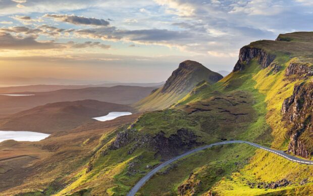 Rolling hills and lakes of Isle of Skye landscape at sunset