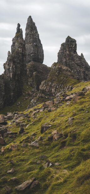 Tall rocky formations on a grassy hill in Isle of Skye