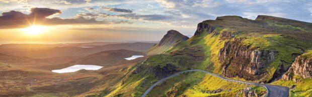 Sunrise over rugged hills and winding road on Isle of Skye landscape