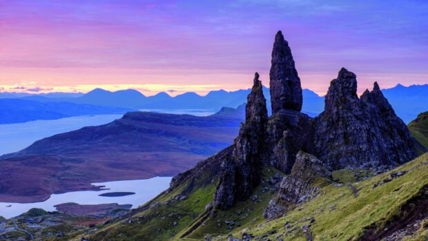 The Old Man of Storr rock formation on Isle of Skye landscape under purple sky