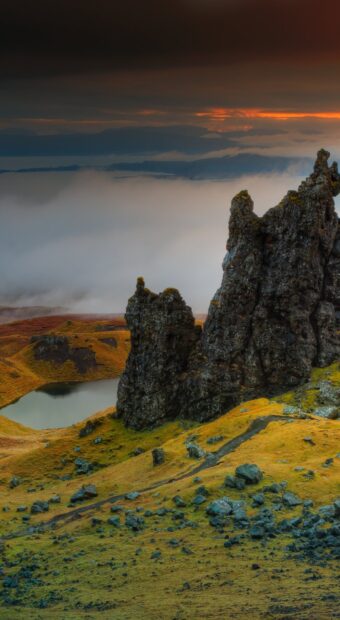 Rocky landscape of Isle of Skye with hills and fog in the distance