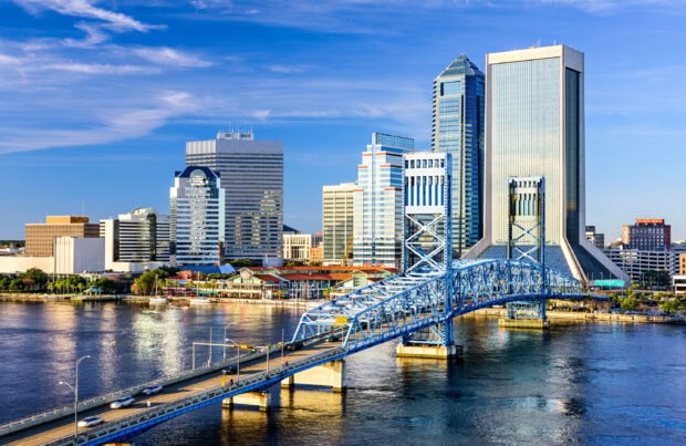 View of Jacksonville skyline with the city bridge over the river on a sunny day