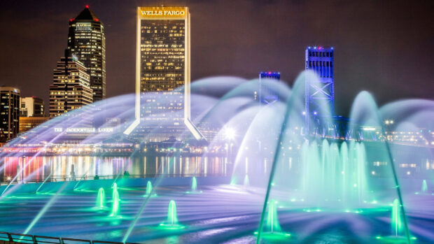 Night view of Jacksonville skyline with fountains and Wells Fargo building