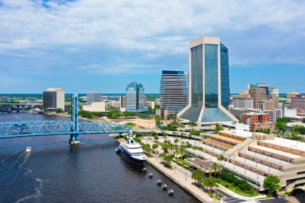 Skyline view of Jacksonville with river bridge and modern buildings in daylight