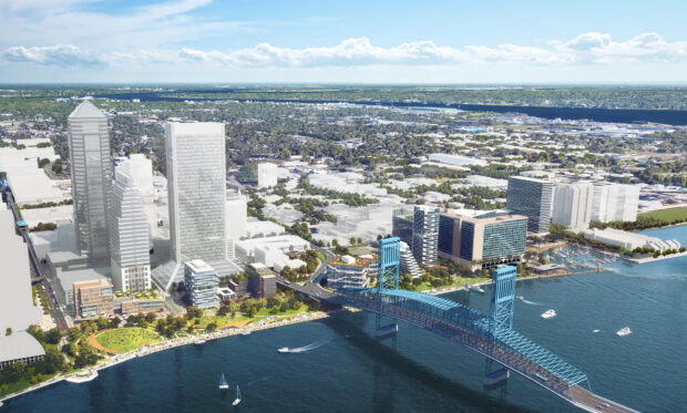 Aerial view of Jacksonville cityscape with river and bridge in a vibrant urban setting