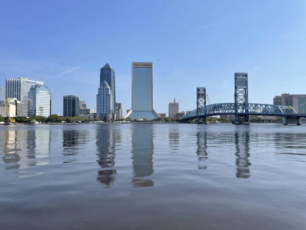 Clear view of Jacksonville skyline with river reflections on a bright sunny day