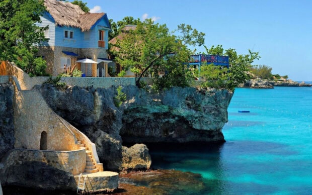 A cliffside villa surrounded by lush foliage in Jamaica