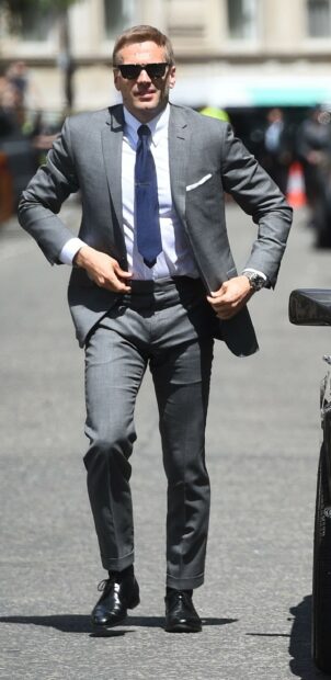 Man wearing a suit and tie walking confidently on the street James Bond