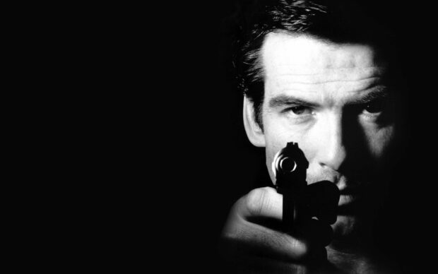 James Bond aiming a gun with intense focus in a dramatic black and white scene