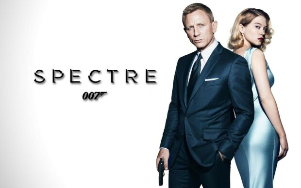 James Bond character standing in a suit with a woman in a blue dress behind him in Spectre movie scene