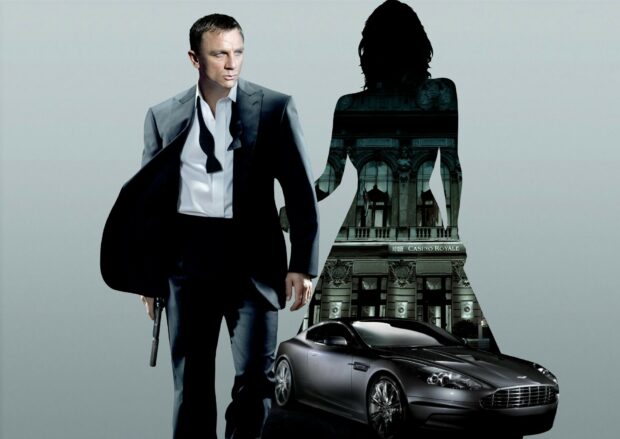 James Bond in a suit holding a gun standing next to a silhouette with a building and a car visible inside the shape