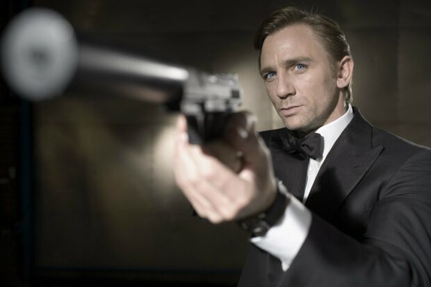 James Bond aiming a gun wearing a tuxedo in a tense action scene