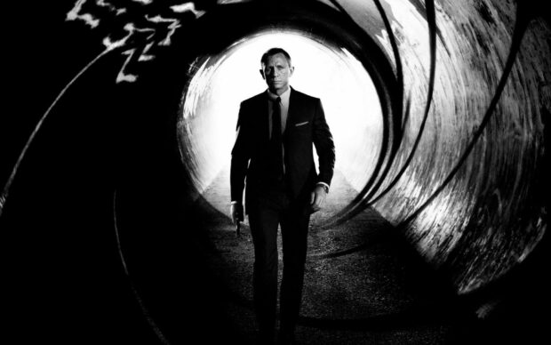 James Bond walking confidently with a gun in a dark tunnel James Bond