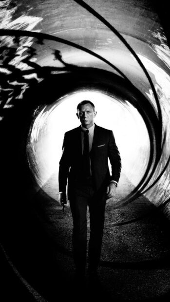 James Bond walking with a gun inside a tunnel in a sharp suit
