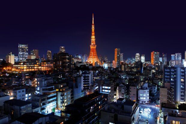 Japan skyline featuring illuminated Tokyo Tower at night with surrounding city buildings