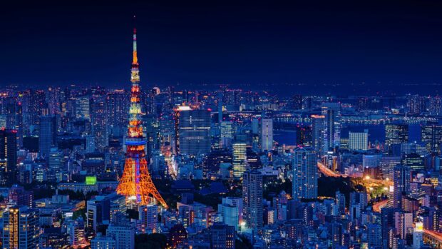 Illuminated Japan skyline featuring Tokyo Tower at night with city lights and skyscrapers