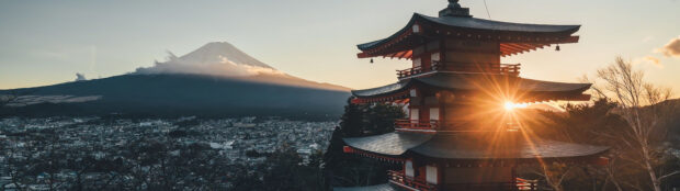 Traditional Japan skyline with Mount Fuji and pagoda at sunset sunlight shining through