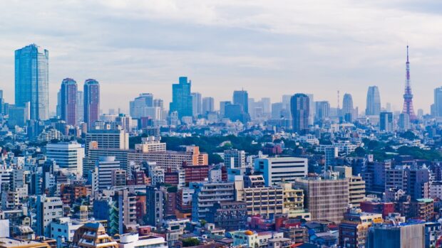 A vibrant Japan skyline featuring Tokyo Tower and modern skyscrapers in clear weather