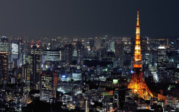 Tokyo skyline illuminated at night with Japan tower glowing brightly among city buildings