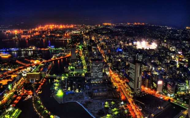 Japan skyline with illuminated streets and buildings at night showcasing city lights and harbor area