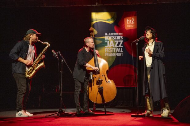 Jazz musicians performing on stage with saxophone and double bass at a jazz festival