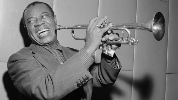 A joyful jazz musician playing trumpet with expressive face in a classic suit