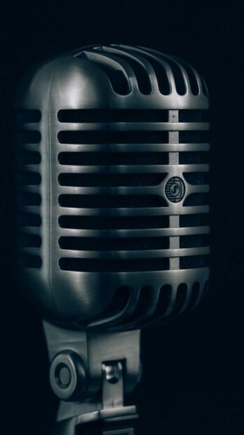 Vintage microphone close up with jazz sound detail in dark background