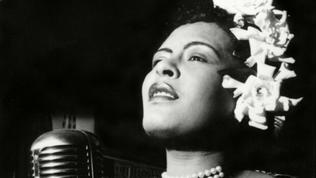 Classic jazz singer wearing pearls and flowers performing on stage