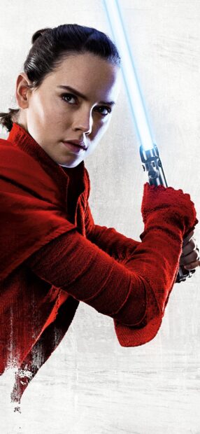 Female Jedi holding a glowing lightsaber wearing a red outfit and focusing ahead