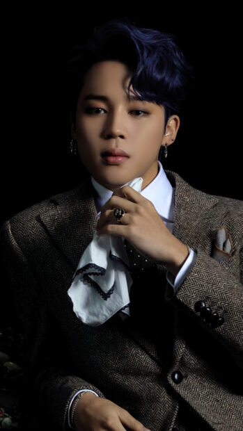 Jimin wearing a brown suit holding a white handkerchief with styled dark blue hair