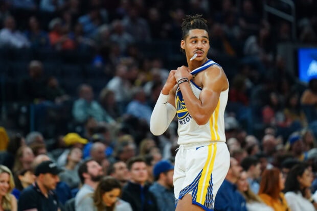 Jordan Poole prepares for the next play during an intense basketball game