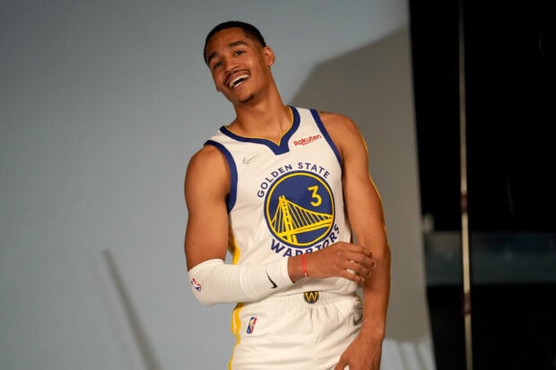 Jordan Poole smiling in a Golden State Warriors basketball uniform
